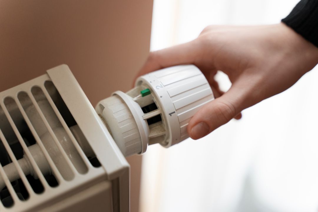 Plumber repairing a radiator and heating system